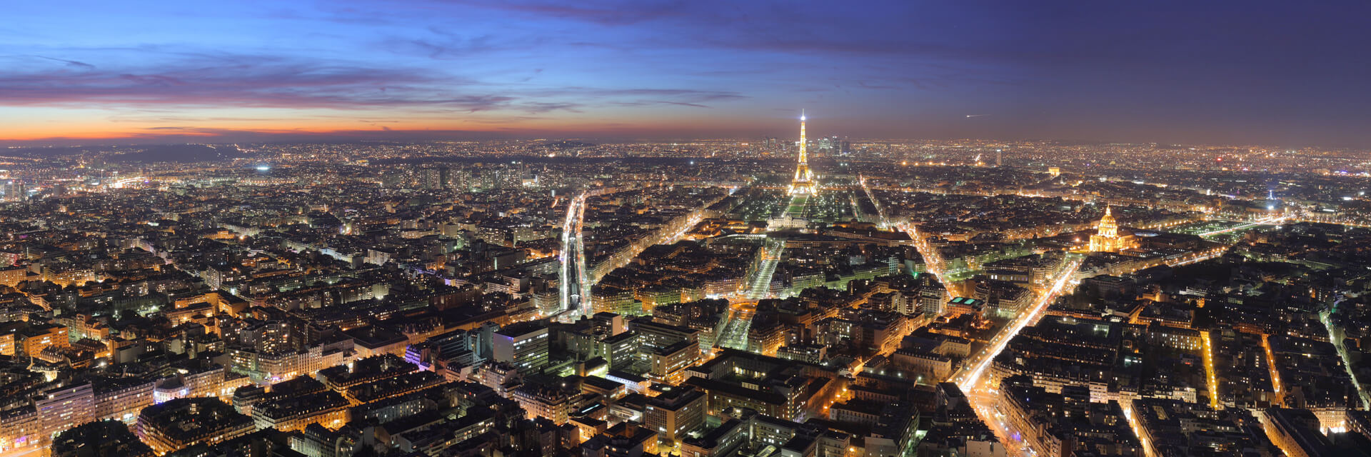 Paris at night seen from above, with the Eiffel Tower