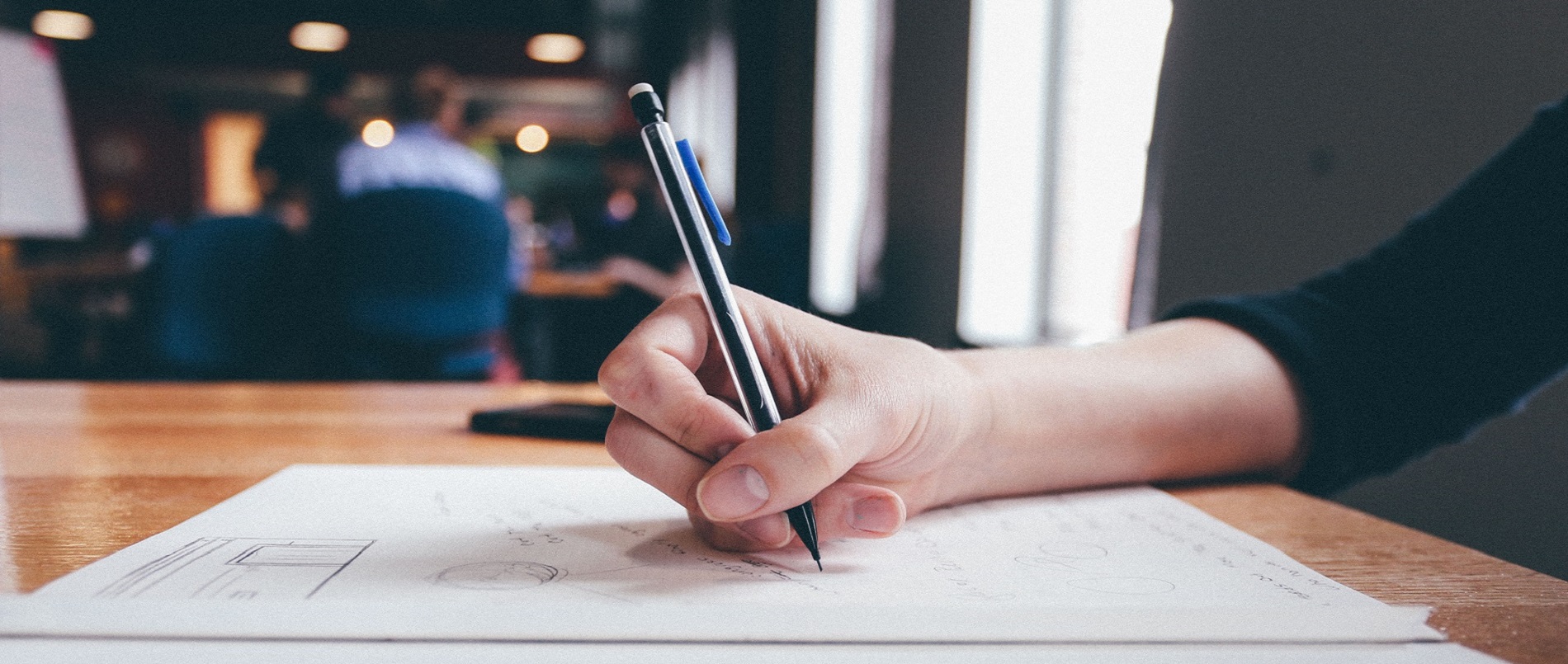A hand writing on a document